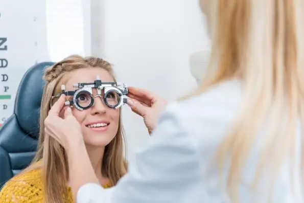 oculist-and-young-patient-with-trial-frame-in-clinic